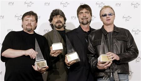 Members of the country band "Alabama" pose with their Award of Merit at the 30th annual American Mus..