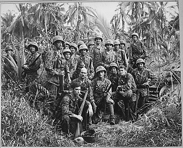 A group of United States Marine Raiders pose for photo in front of a Japanese dugout, on Bougainville, January, 1944.